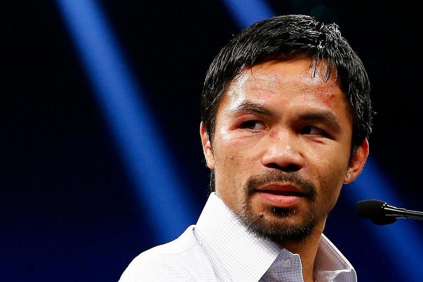 Boxing legend Manny Pacquiao is coy whenever he is asked about wanting the presidency. -- PHOTO: AGENCE FRANCE-PRESSE