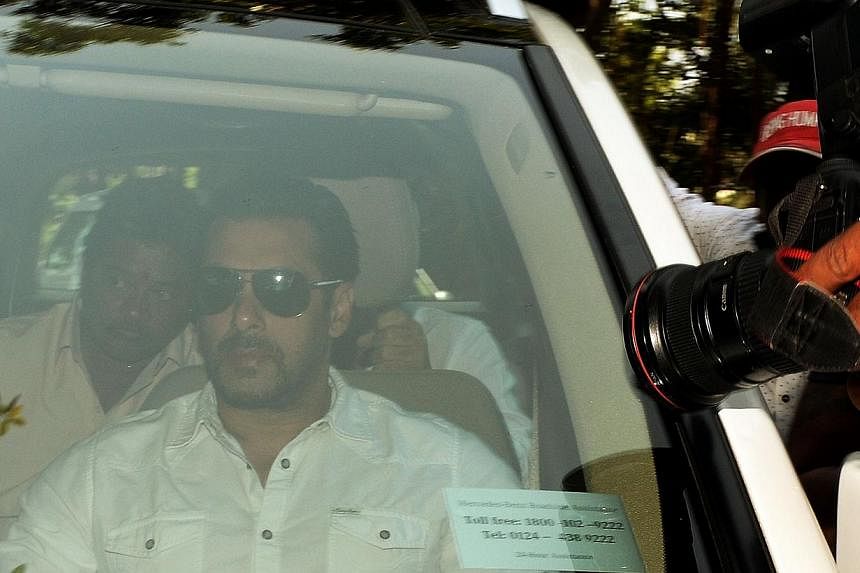 Salman Khan (centre) arriving in a car at a sessions court in Mumbai on May 6, 2015. The Bollywood star was sentenced on Wednesday to five years in prison. -- PHOTO: AFP