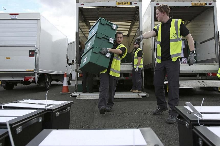 City council workers assemble ballot boxes for distribution ahead of the next day's general election, in Glasgow, Scotland on May 6, 2015.&nbsp;British Prime Minister David Cameron's Conservative Party is one point ahead of the opposition Labour Part