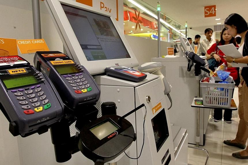 Some new high-tech payment methods such as contactless cards are getting the cold shoulder from Singapore shoppers, who prefer to stick with cash, according to a new study yesterday. -- PHOTO: ST FILE