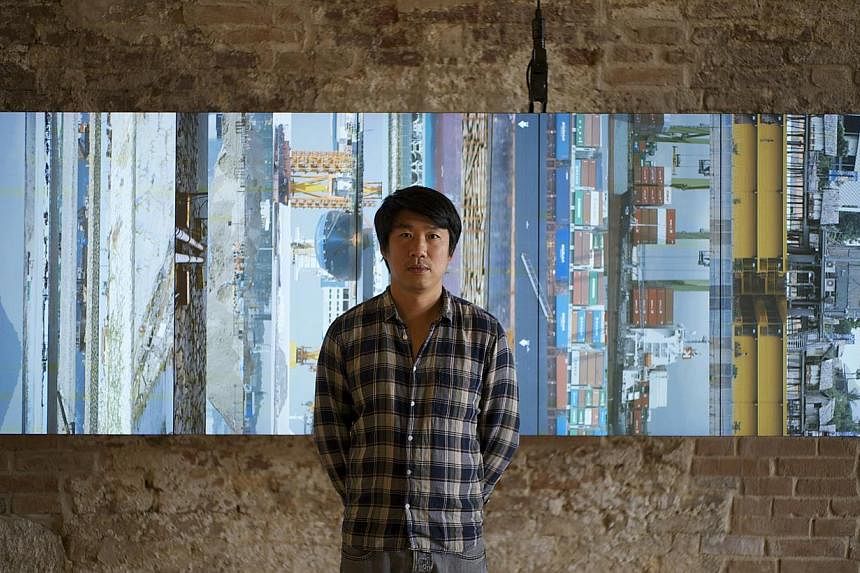 Artist Charles Lim and his installation Sea State at the Singapore Pavilion. Sea State looks at the impact of reclamation and expansion works in Singapore and includes maps, charts, video installations and a 5-m tall aluminium buoy encrusted with bar