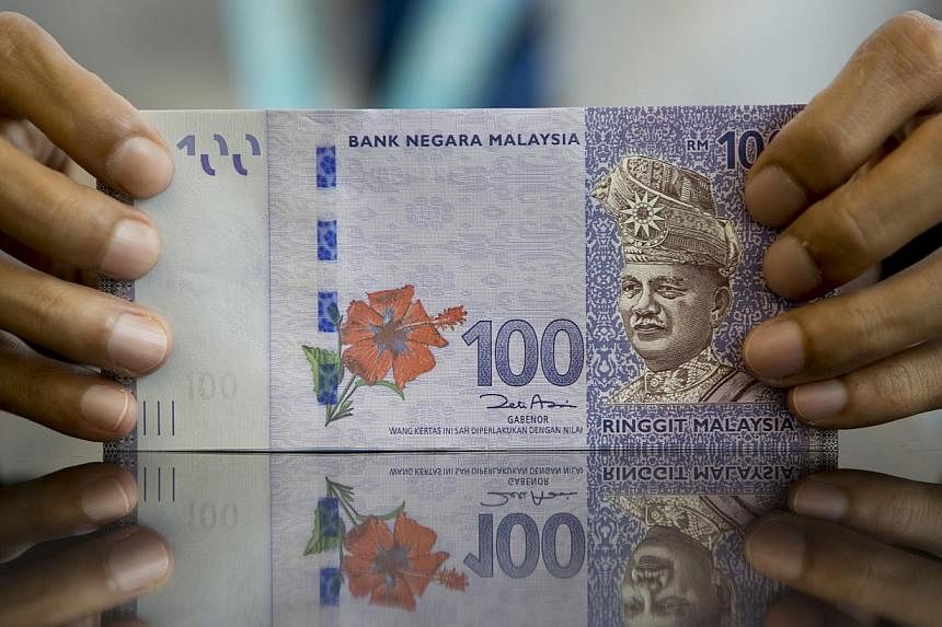 Malaysia's ringgit rose, leading gains in Asia, as a rally in crude prices eased concern that falling revenue will harm the oil-exporting nation. -- PHOTO:&nbsp;BLOOMBERG