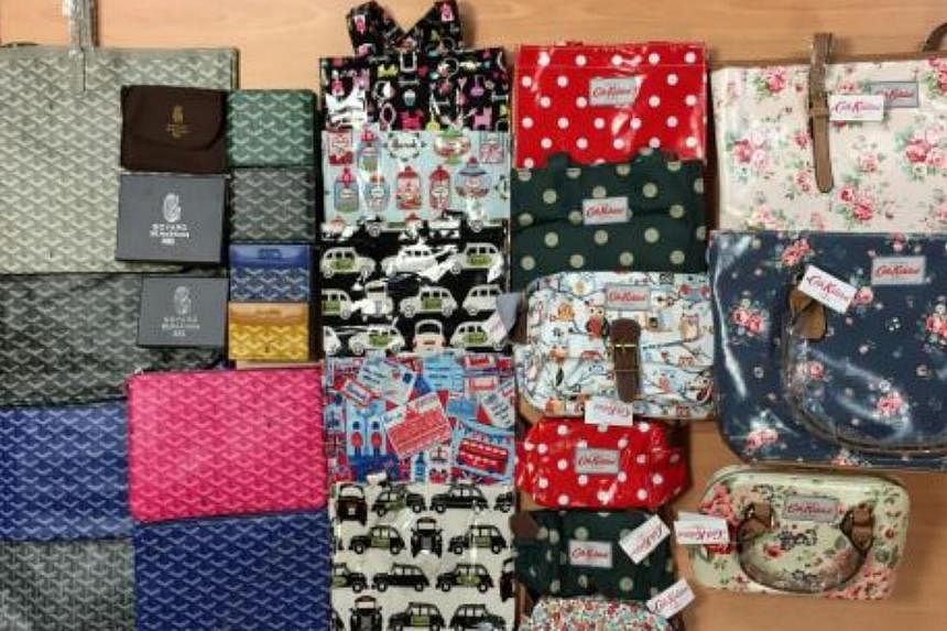 Some of the 700 counterfeit women’s bags and wallets detained by Singapore Customs on May 6, 2015. -- PHOTO: SINGAPORE CUSTOMS