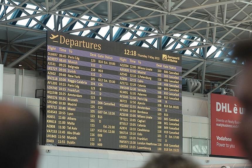 A flights information screen shows cancelled flights at Rome's Fiumicino international airport where a fire broke out overnight at Terminal 3, on May 7, 2015. -- PHOTO: AFP