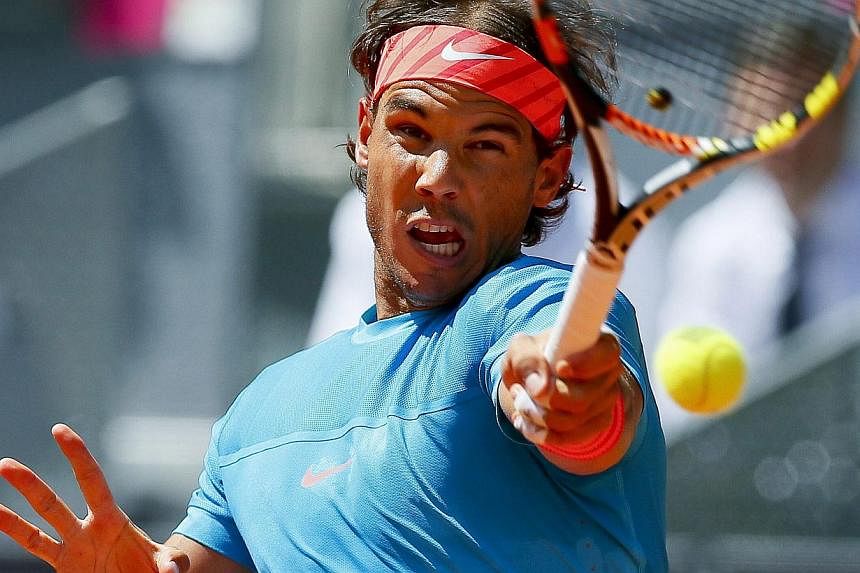Spain's Rafael Nadal returns the ball to Italy's Simone Bolelli during their third round match of the Mutua Madrid Open tennis tournament at the Caja Magica tennis complex in Madrid, Spain, on May 7, 2015. -- PHOTO: EPA