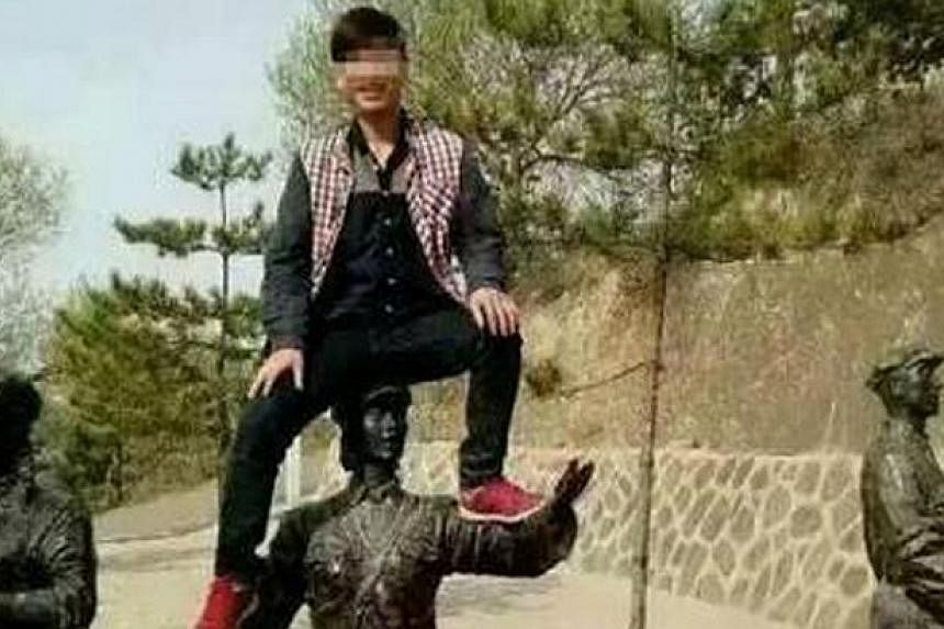 A man was placed on China's tourist blacklist for 10 years for climbing on top of a Red Army statue for a photo at a tourist attraction. -- PHOTO: SINA WEIBO