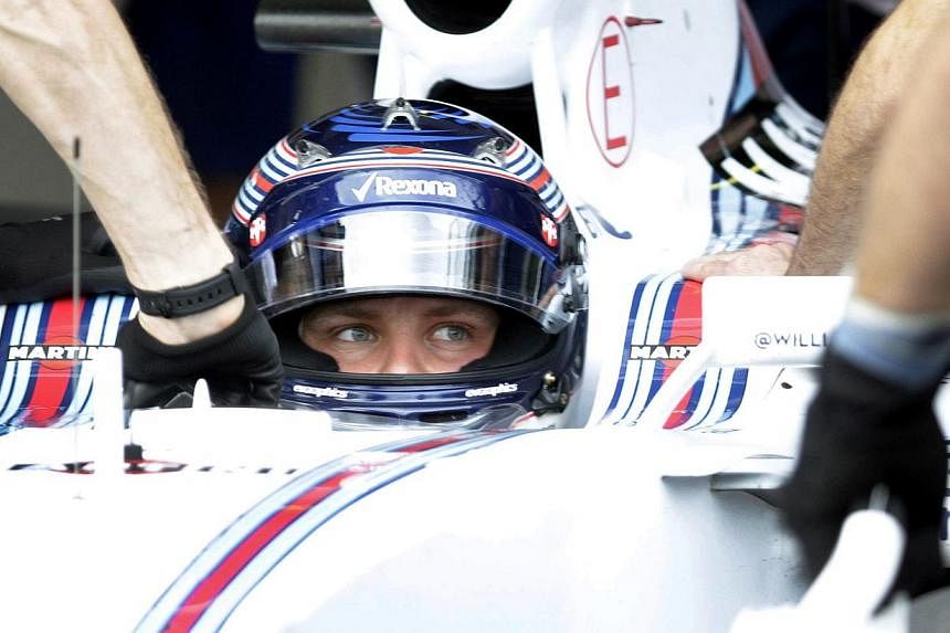 Williams Martini Racing's Finnish driver Valtteri Bottas sits in the pits during qualifying for the Formula One Australian Grand Prix in Melbourne on March 14, 2015. -- PHOTO: AFP&nbsp;