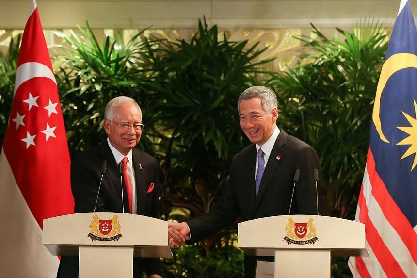 Malaysian Prime Minister Najib Razak (left) and Singapore Prime Minister Lee Hsien Loong, after their annual leaders’ retreat at the Shangri-La Hotel on May 5, 2015. Both pledged their full commitment to realising the high-speed rail link, calling 