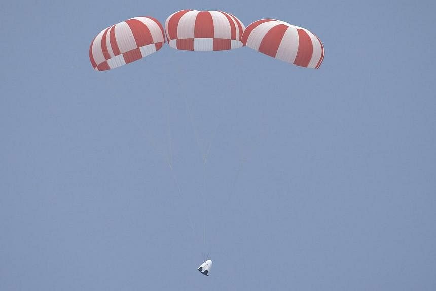 The unmanned SpaceX Crew Dragon lands after lifting off from launch pad 40 during a Pad Abort Test at the Cape Canaveral Air Force Station in Cape Canaveral, Florida on Wednesday. -- PHOTO: REUTERS