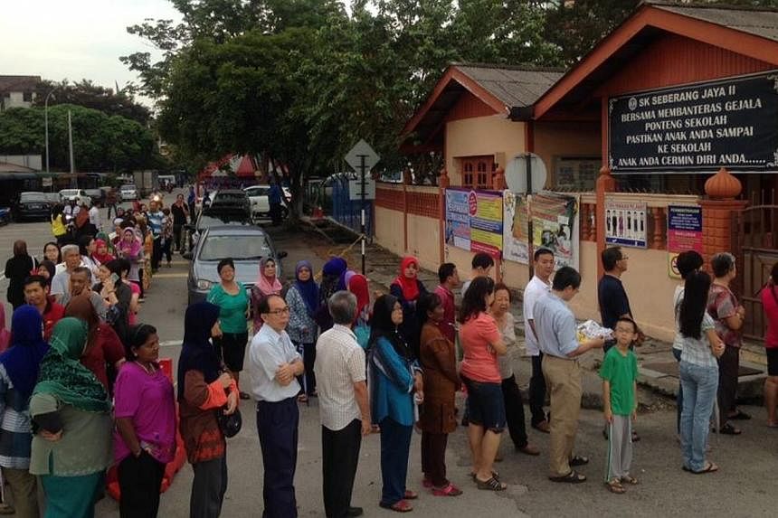Polls for the Permatang Pauh parliamentary by-election opened at 8am on Thursday with voters lining up from very early to cast their ballots. -- PHOTO: THE STAR/ASIA NEWS NETWORK