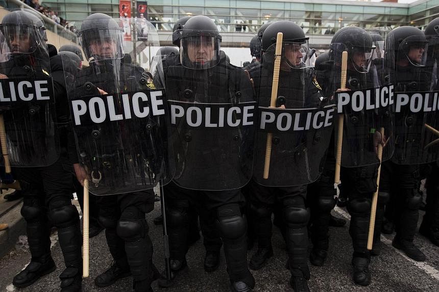 An April 25, 2015 photo shows riot police holding their position during a protest in Baltimore, Maryland, against the death of Freddie Gray while in police custody. US Attorney-General Loretta Lynch will launch a federal probe into whether Baltimore'