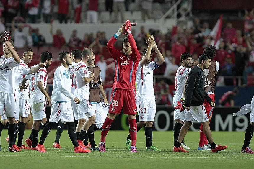 Sevilla players celebrating their victory against Fiorentina at the Ramon Sanchez Pizjuan stadium in Seville, Spain, on May 7, 2015. -- PHOTO: EPA