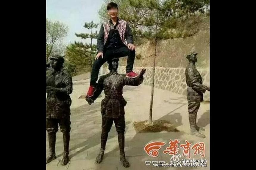 Li Wenchun has been punished for climbing onto a statue depicting a soldier of the Red Army at a commemorative park in China last month.