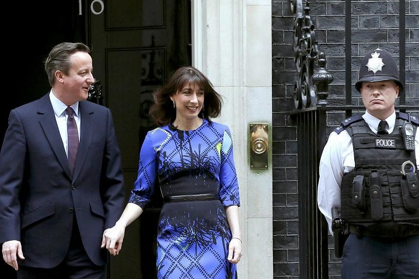 Britain's Prime Minister David Cameron and his wife Samantha leave Number 10 Downing Street to meet with Queen Elizabeth at Buckingham Palace in London May 8, 2015. -- PHOTO: REUTERS&nbsp;
