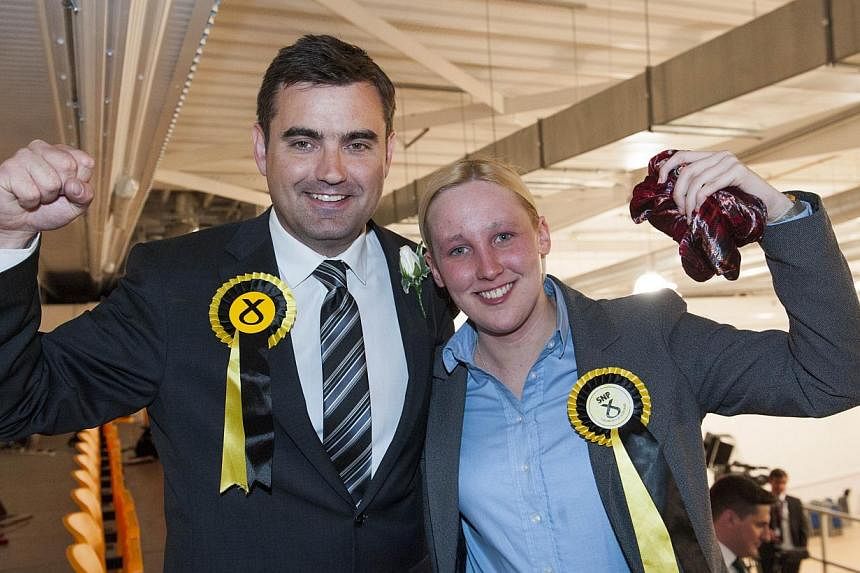Scottish National Party (SNP) Member of Parliament Mhairi Black (right), Britain's youngest MP since 1667, with also newly elected SNP MP Gavin Newlands. -- PHOTO: AFP&nbsp;