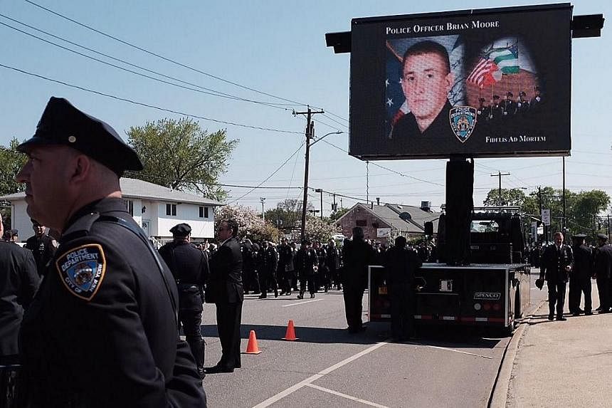Police officers gather for the funeral of officer Brian Moore at St James Roman Catholic Church May 8, 2015 in Seaford, New York. Police lined the streets of a Long Island town where thousands attended the funeral Friday of a New York officer alleged