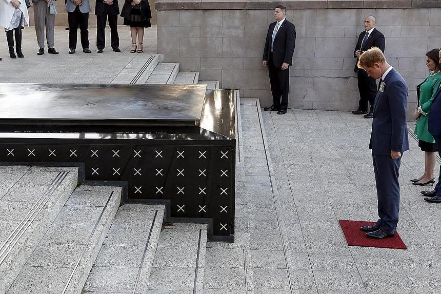 Britain's Prince Harry pays respect at the Tomb of the Unknown Warrior at the National War memorial in Wellington on May 9, 2015. -- PHOTO: REUTERS
