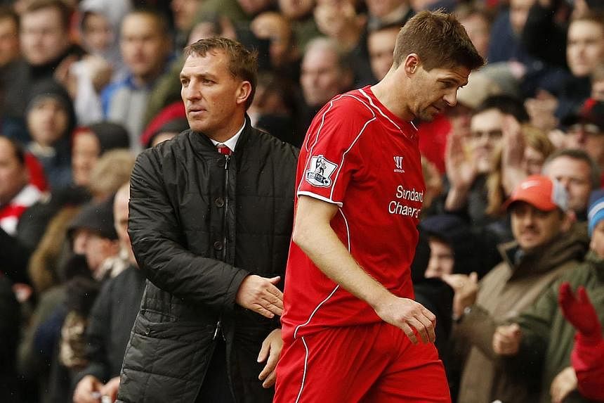 Liverpool manager Brendan Rodgers (left) and player Steven Gerrard. Liverpool must reluctantly subject themselves to the after-glow of Chelsea's Premier League title triumph on Sunday as they seek to keep their slim hopes of Champions League qualific