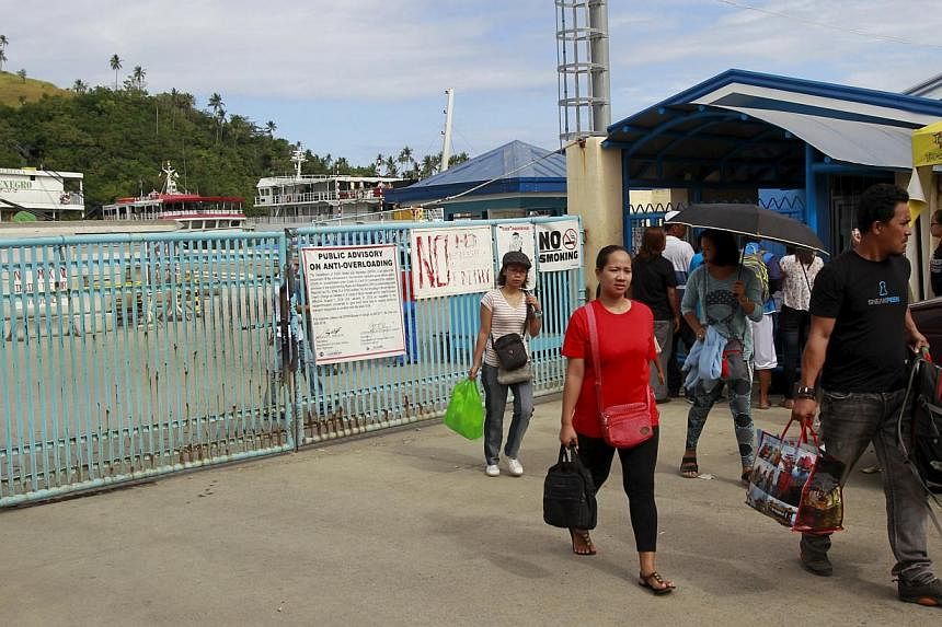 Stranded passengers leaving a port after learning that ferry services were stopped in preparation for an approaching storm in Marinduque island, central Philippines, on April 4, 2015. -- PHOTO: REUTERS&nbsp;