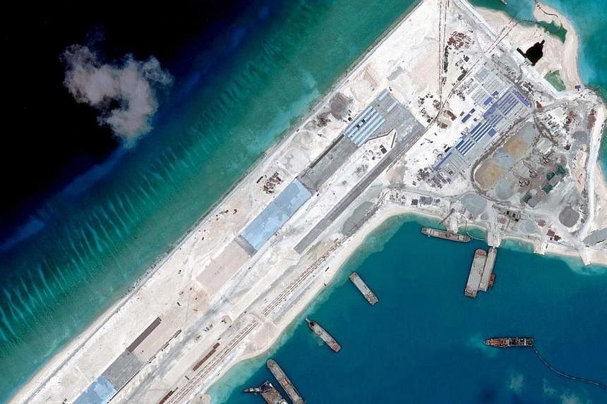 A satellite image from April 2015 showing China's construction of a runway on Fiery Cross Reef in the Spratly Island chain, estimated at 3.1km in total. -- PHOTO: REUTERS