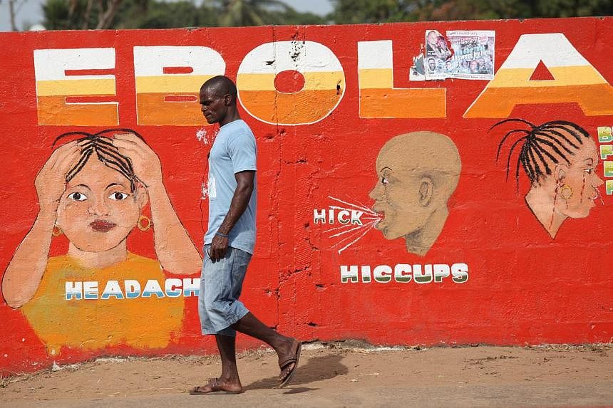 A file picture dated 22 March 2015 shows a Liberian man walking pass an ebola awareness painting on a wall in downtown Monrovia, Liberia. Liberia is declared free from Ebola on April 9, 2015 after 42 days without a new case, the medical charity Medec