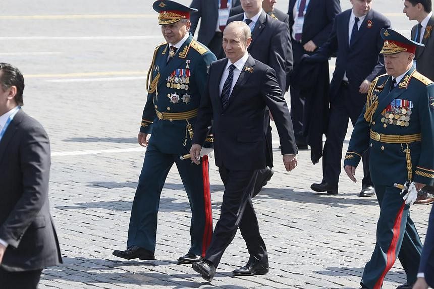 Russian President Vladimir Putin (third left) and Russian Defence Minister Sergei Shoigu (second left) walk after the Victory Day military parade in the Red square in Moscow, Russia, May 9, 2015. -- PHOTO: EPA &nbsp;
