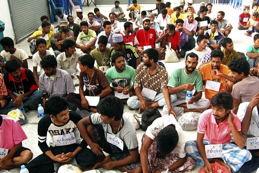 Suspected ethnic Rohingya migrants from Myanmar and Bangladesh rest as they were detained at the district hall in Rattaphum district, Songkhla province southern Thailand on May 9, 2015. -- PHOTO: EPA