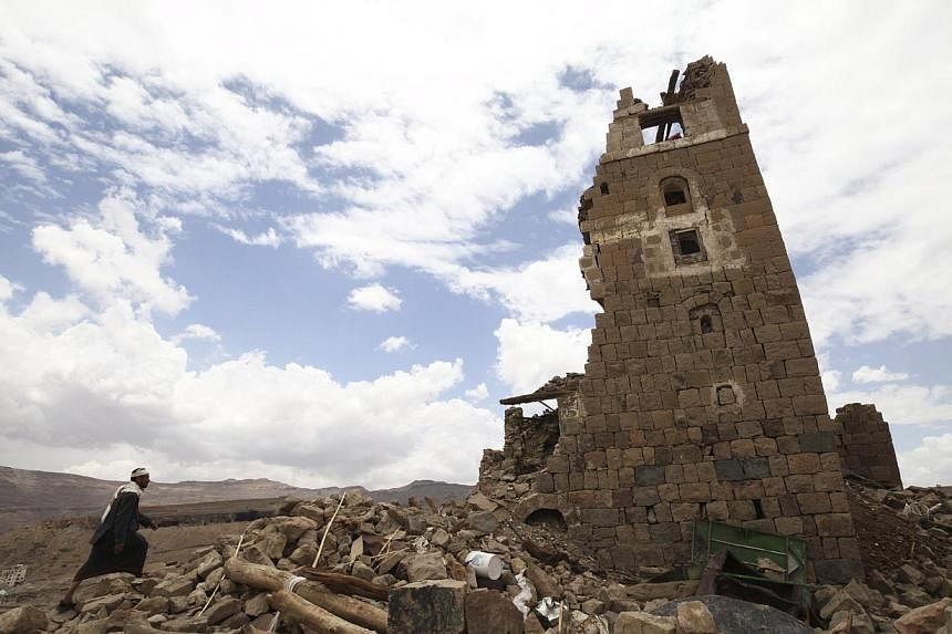 A man walks to a house that was damaged during an airstrike carried out by the Saudi-led coalition in Faj Attan village, Sanaa, Yemen May 7, 2015. -- PHOTO: REUTERS&nbsp;