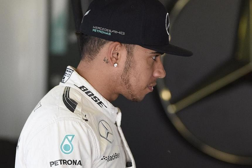 Britain's Lewis Hamilton stands in the pits during the second practice session at the Circuit de Catalunya on May 8, 2015, ahead of the Spanish Formula One Grand Prix. -- PHOTO: AFP