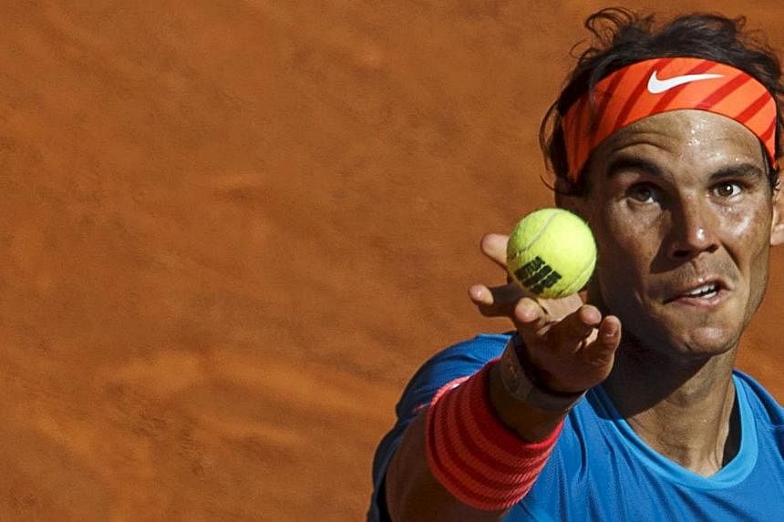 Spain's Rafael Nadal serves to the Czech Republic's Tomas Berdych during their semi-final match at the Madrid Open tennis tournament on May 9, 2015. -- PHOTO: REUTERS