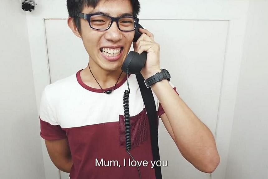 Screenshot of a video by Jurong Point Shopping Centre to celebrate Mother's Day which falls on May 10 this year. It shows people talking to their mothers over the phone in a booth set up in the mall. -- PHOTO: JURONG POINT SHOPPING CENTRE