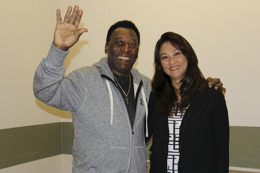 Brazilian&nbsp;football legend Pele (left) waves with his wife Marcia Cibele Aoki at the Albert Einstein Hospital in Sao Paulo in this May 9, 2015, handout photograph from his family, courtesy of the hospital. Brazilian football legend Pele was relea
