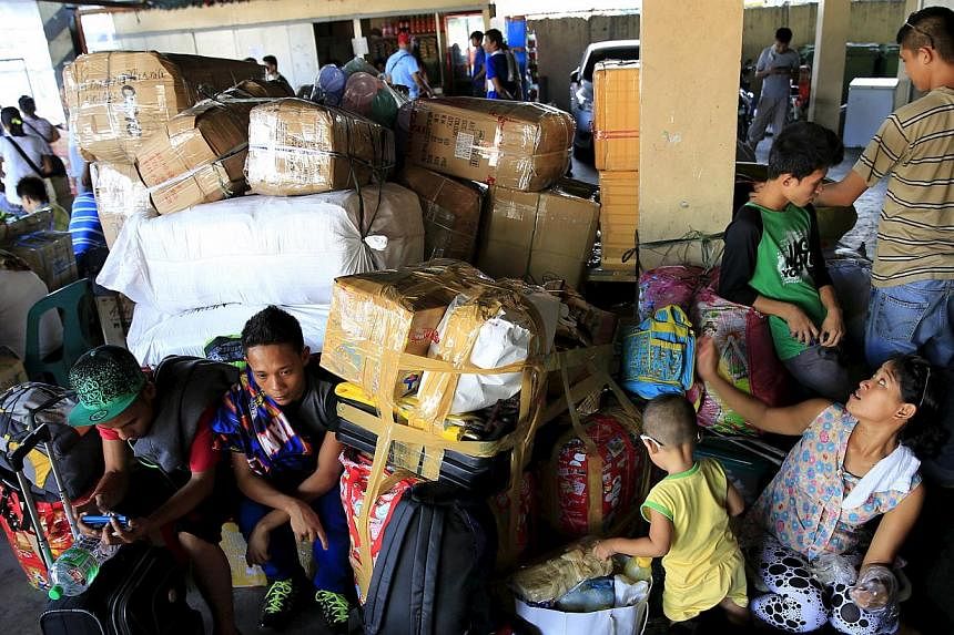 Stranded passengers guard their belongings while waiting at a bus terminal in Manila on May 9, 2015. -- PHOTO: REUTERS&nbsp;
