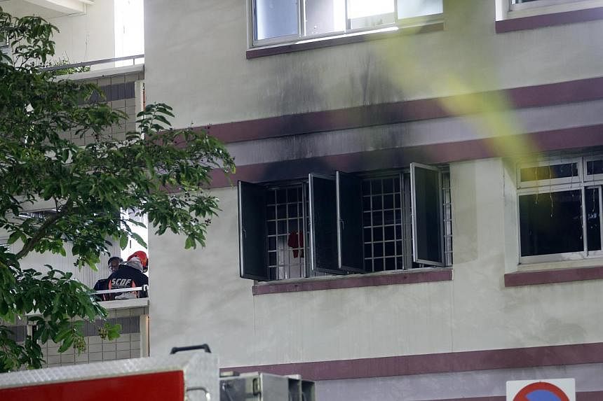 Scorch marks can be seen outside the window of the flat that caught fire in Tampines on Sunday night.&nbsp; -- ST PHOTO: CHEW SENG KIM