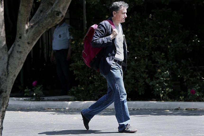 Wearing blue jeans, Greek minister of International Economic Relations Euclid Tsakalotos arrives for a cabinet meeting at the Prime minister's office in Athens on Sunday a day ahead a Eurogroup meeting. -- PHOTO: AFP&nbsp;