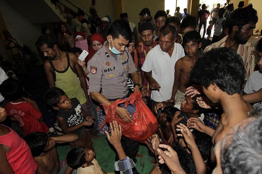 Rohingya refugees line up for breakfast in the sport stadium of Lhok Sukon, North Aceh, Sumatra, Indonesia on May 11,&nbsp;2015. Bangladeshi police arrested three human traffickers on Monday after killing four in recent days and arresting more than 1
