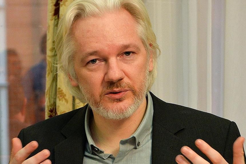 WikiLeaks founder Julian Assange gestures during a press conference inside the Ecuadorian Embassy in London on August 18, 2014. Sweden's Supreme Court says it had rejected an appeal by Assange against his arrest warrant for alleged rape and sexual as