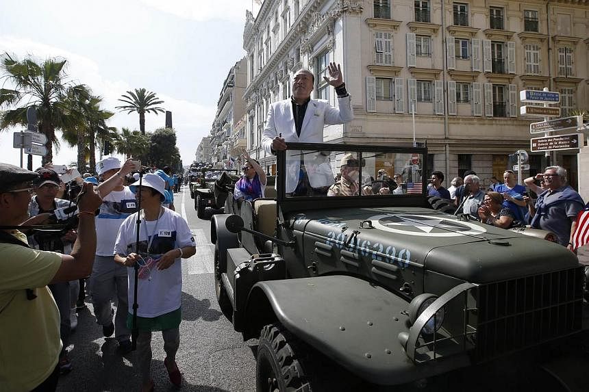Li Jinyuan, chairman of Chinese company Tiens Group, parading in the French Riviera city of Nice. The company invited 6,400 of its employees to celebrate its 20th anniversary in France. -- PHOTO: AFP