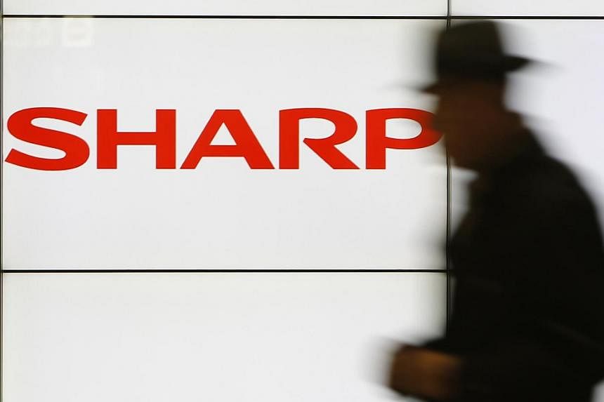 Shares in Japan's Sharp plunged 31 per cent on Monday after weekend media reports that the struggling electronics maker is planning a drastic capital reduction to help wipe away losses. -- PHOTO: REUTERS