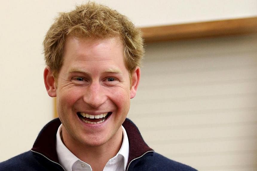 Britain's Prince Harry laughs as he meets locals at the Stewart Island community centre during his visit to Stewart Island in the south of New Zealand on May 10, 2015. -- PHOTO: REUTERS