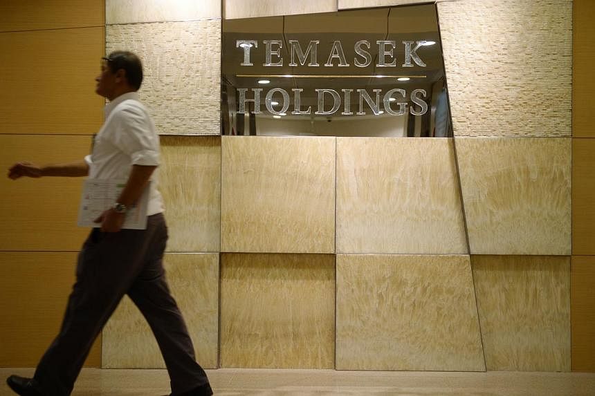 A man walks pass the Temasek Holdings office on Feb 16, 2015. A constitutional change was sought on Monday to make Temasek Holdings a bigger contributor to the Government's coffers, as Singapore prepares for more&nbsp;social and infrastructure spendi