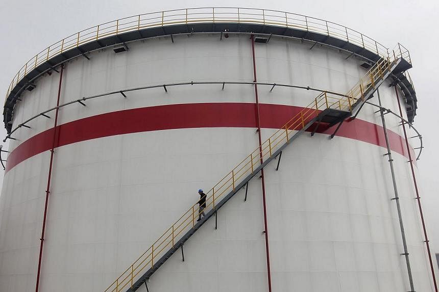 A worker walks down the stairs of an oil tank at a refinery in Wuhan, Hubei province on March 23, 2012. China overtook the United States as the world's top importer of crude oil for the first time in April, and its purchases are expected to remain st