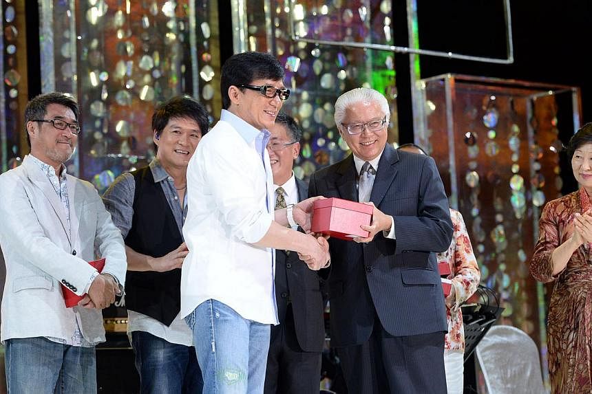 (From left) Celebrities Jonathan Lee, and Wakin Chau look on as Hong Kong star Jackie Chan receives a token of appreciation from President Tony Tan Keng Yam during the Love from the Stars gala. Mrs Mary Tan is on the right.&nbsp;The gala, held at Res