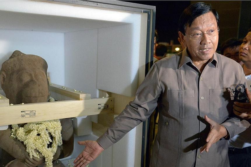 Cambodian secretary of state of council of ministers Chan Tany talks to media alongside a 10th-century statue of the Hindu monkey god Hanuman upon its arrival at Phnom Penh International Airport on May 10, 2015. The&nbsp;Cleveland Museum of Art&nbsp;