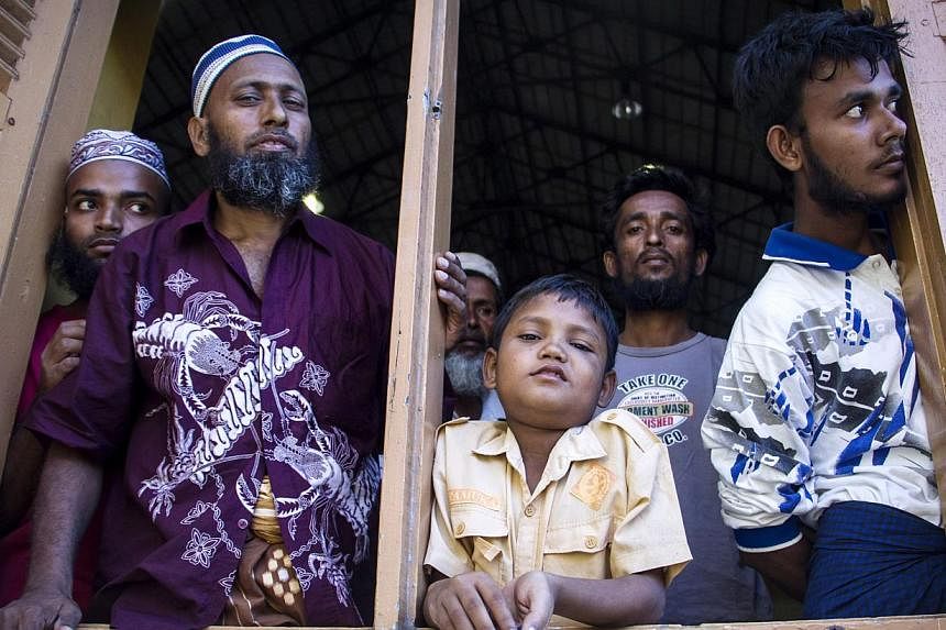 Migrants from Myanmar and Bangladesh at a police station in Kuah, Langkawi, in the Malaysian state of Kedah on May 11, 2015. -- PHOTO: EPA&nbsp;