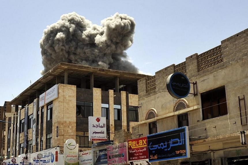 Smoke rises above the residence of former Yemeni President Ali Abdullah Saleh following an airstrike carried out by the Saudi-led alliance in Sana’a, Yemen on Sunday. -- PHOTO: EPA