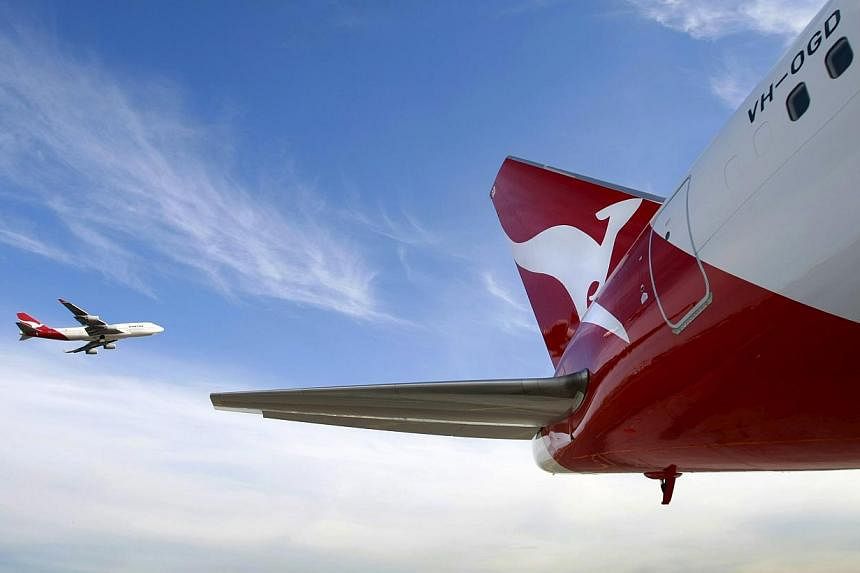 Shares of Qantas Airways surged to their highest level in more than six years in Sydney after Australia's biggest carrier said the global drop in oil prices would help cut its fuel bill this year. -- PHOTO: REUTERS