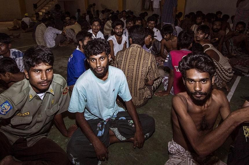 A group of rescued migrants mostly Rohingya migrants from Myanmar and Bangladesh are temporarily housed at a government sports auditorium in Lhoksukon, Aceh province, on May 11, 2015. -- PHOTO: AFP