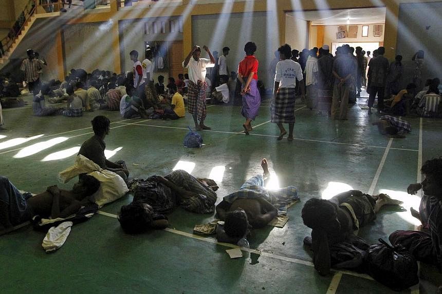 Migrants believed to be Rohingya are seen inside a shelter after being rescued from boats, in Lhoksukon, Indonesia's Aceh Province, on May 11, 2015. -- PHOTO: REUTERS
