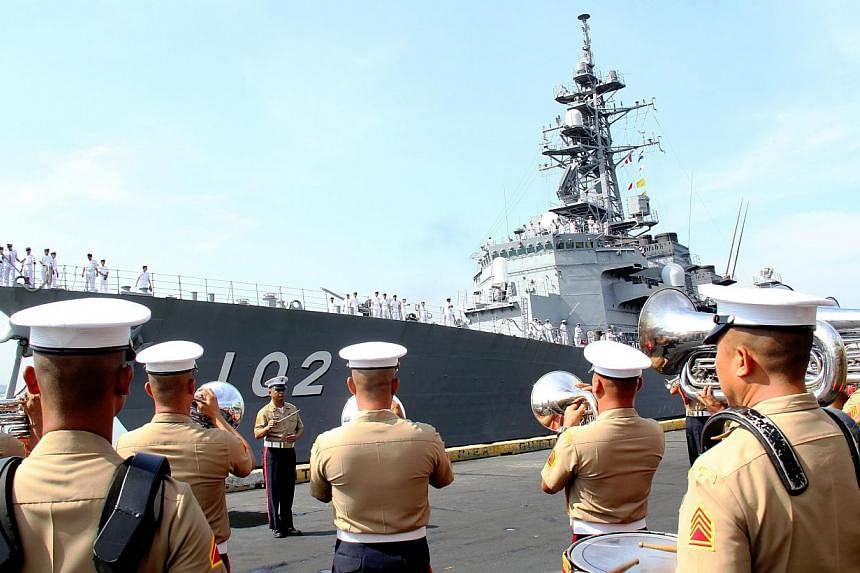 A handout picture released by the Philippine Navy Public Affairs Office shows the arrival of the Japanese navy (back) at Manila South harbor, Philippines on May 9, 2015. -- PHOTO: EPA